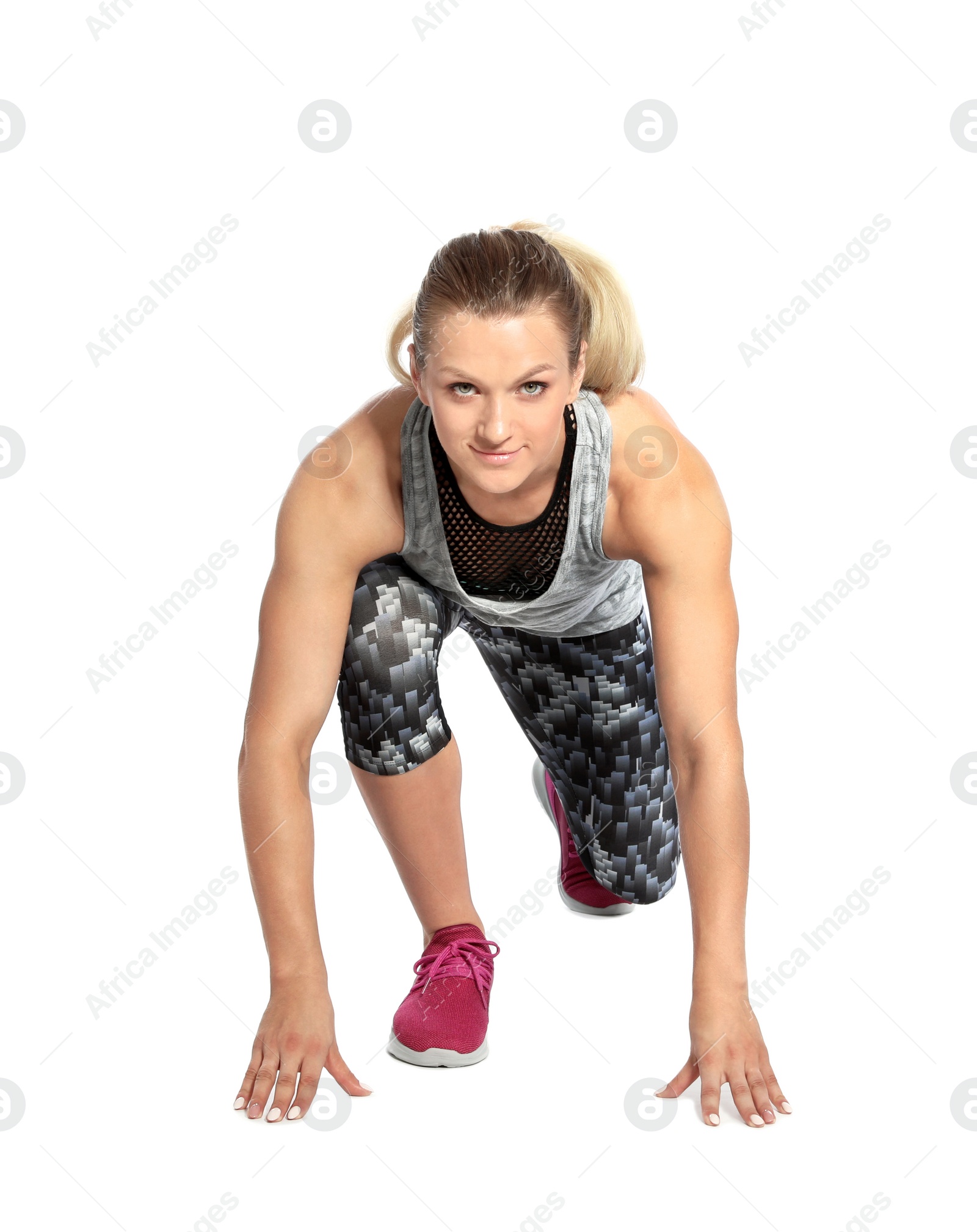 Photo of Young woman ready to run on white background