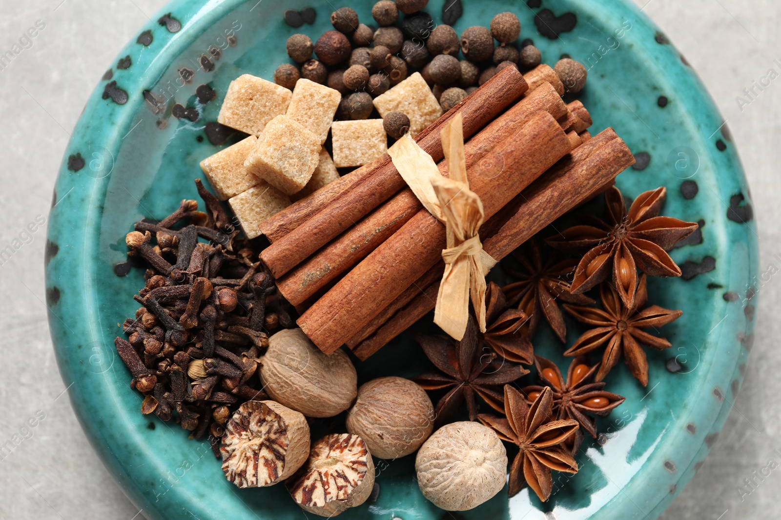 Photo of Different aromatic spices on light table, top view