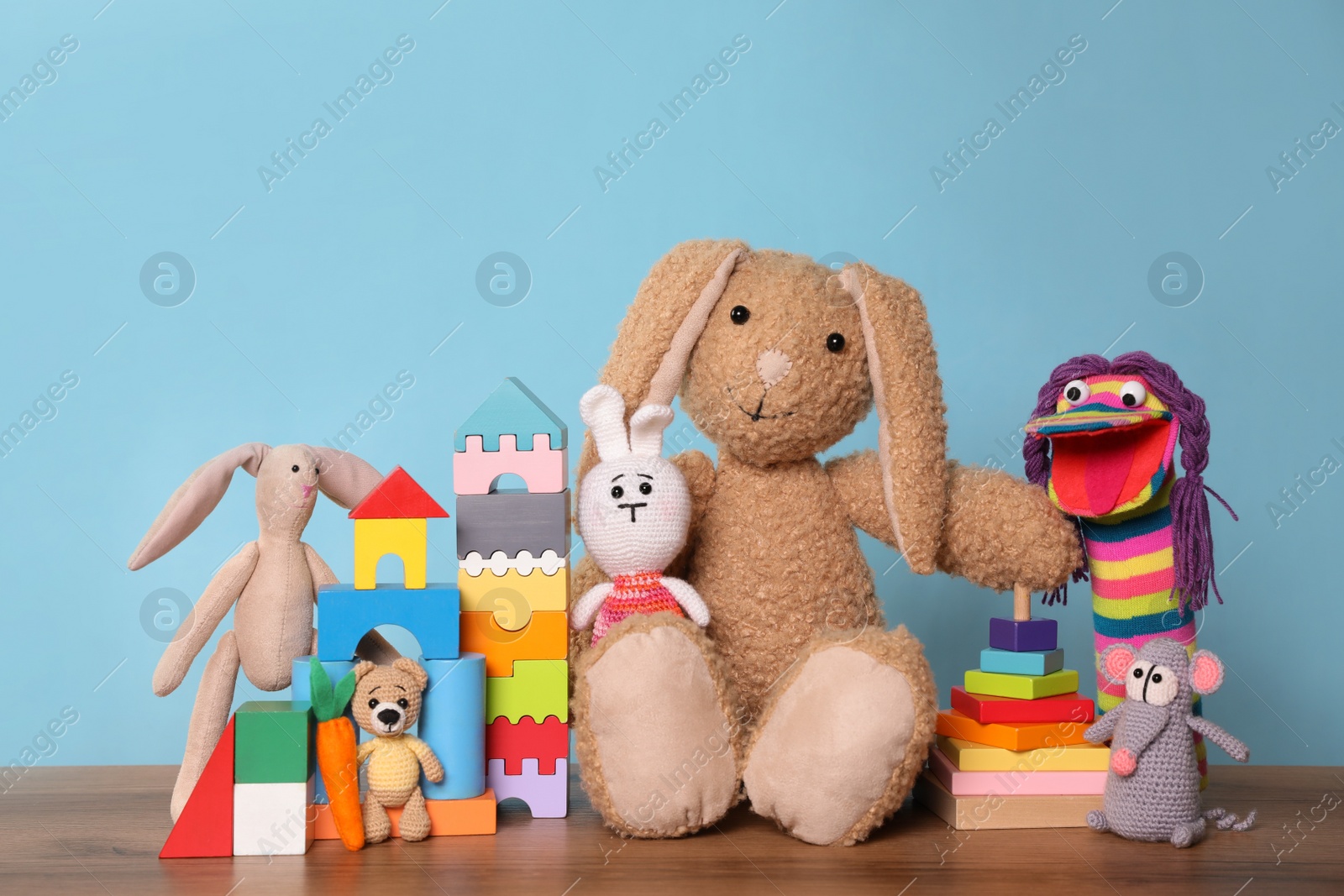 Photo of Collection of different toys on wooden table