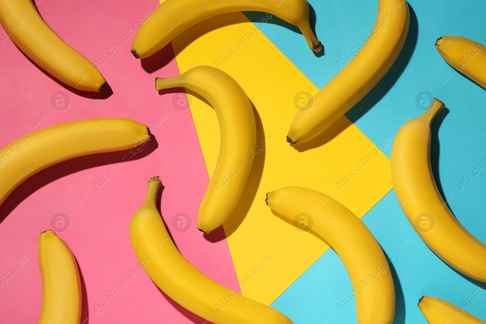 Photo of Ripe yellow bananas on color background, flat lay