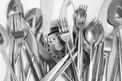Photo of Washing silver spoons, forks and knives in kitchen sink, flat lay