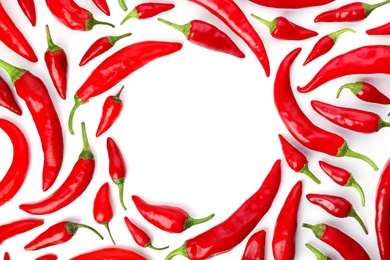 Photo of Frame made of red chili peppers on white background, top view. Space for text
