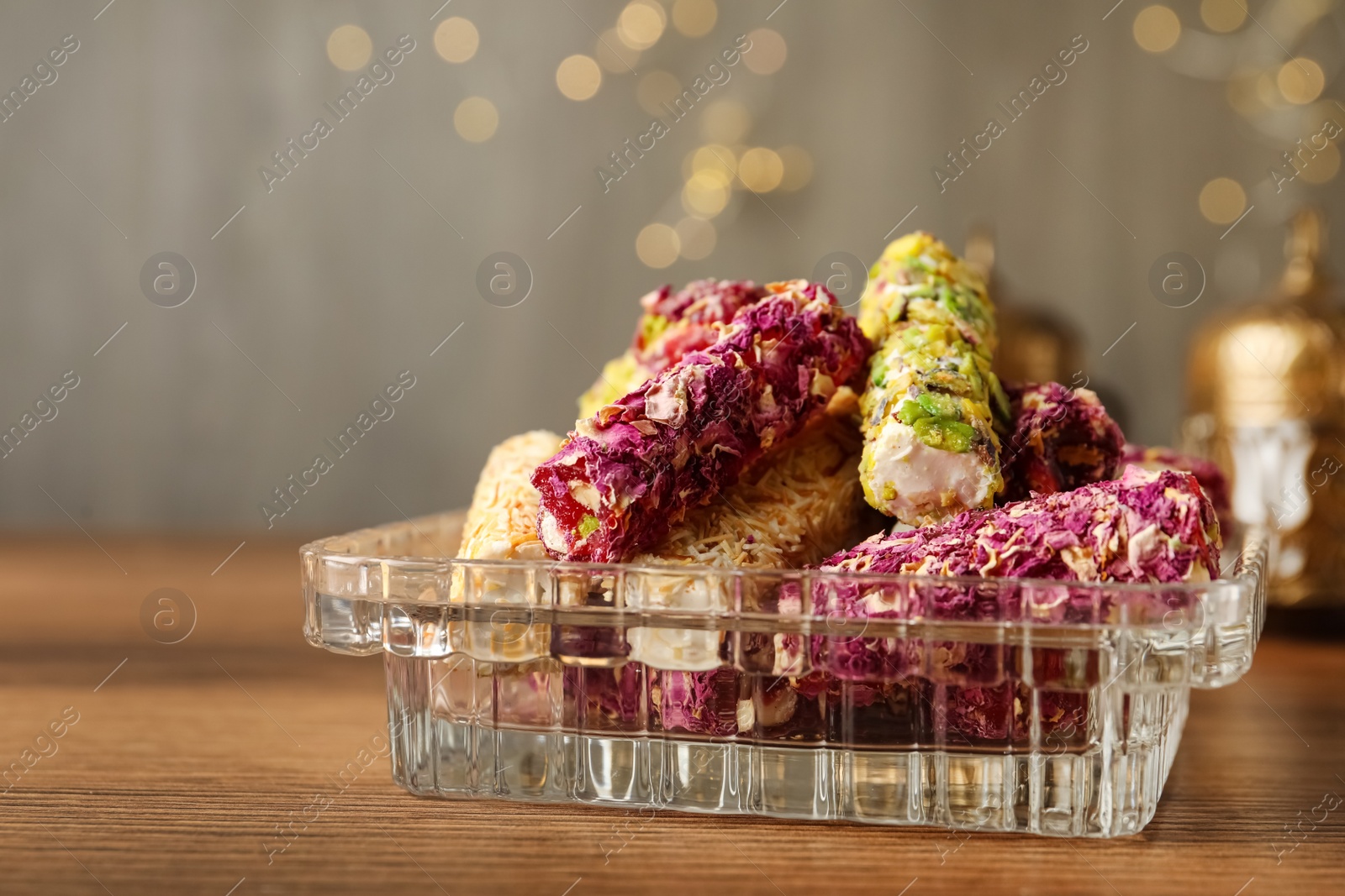 Photo of Turkish delight dessert on wooden table, closeup. Space for text