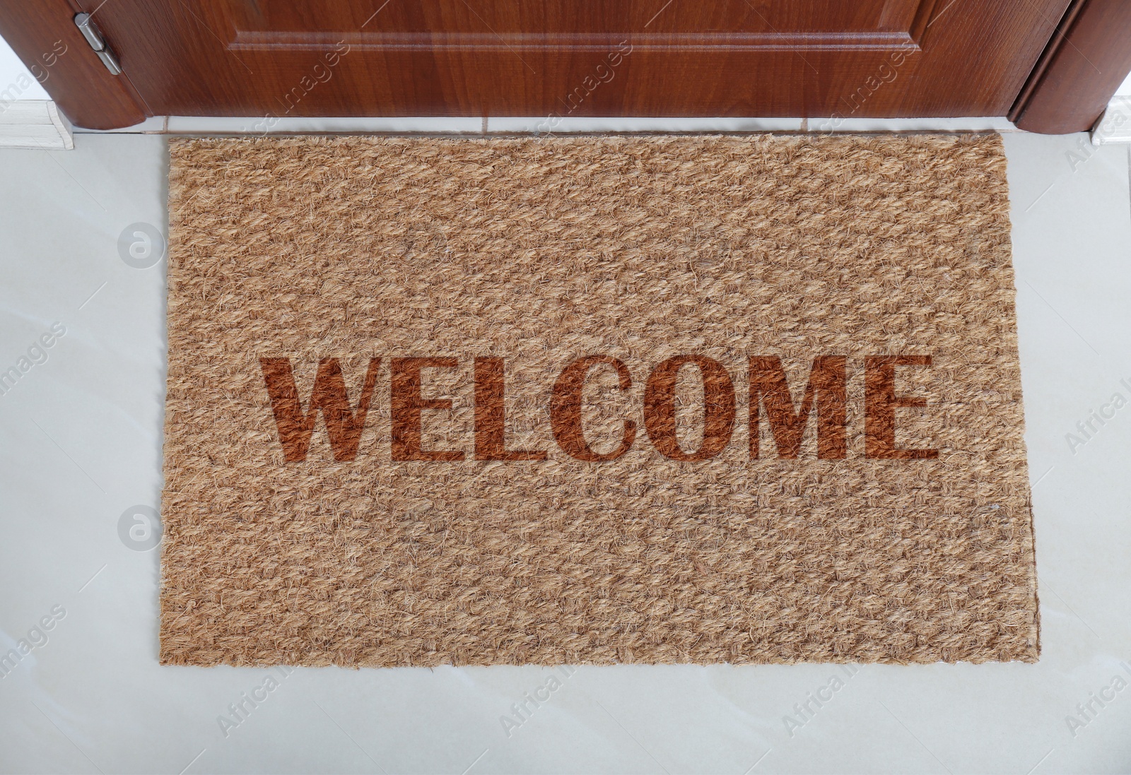 Image of Door mat with word WELCOME near entrance, top view