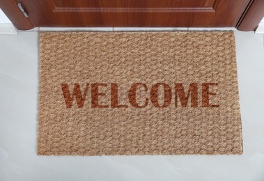 Image of Door mat with word WELCOME near entrance, top view