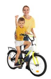 Photo of Young mother teaching son to ride bicycle on white background