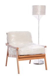 Armchair and lamp wrapped in stretch film on white background