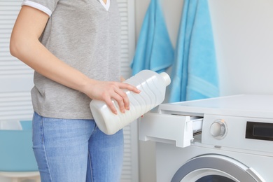 Young woman doing laundry at home, closeup