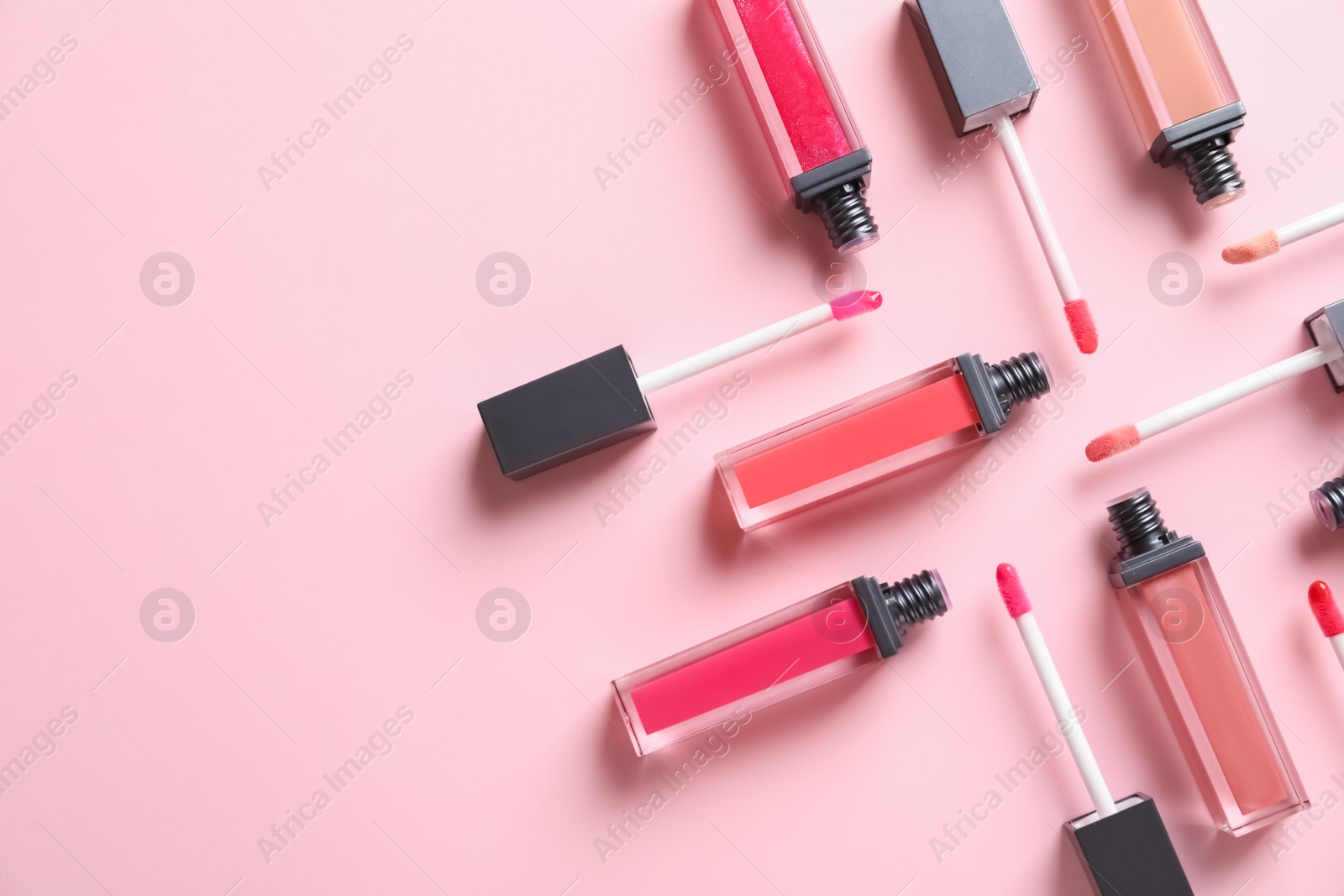 Photo of Composition of liquid lipsticks on color background, flat lay. Space for text