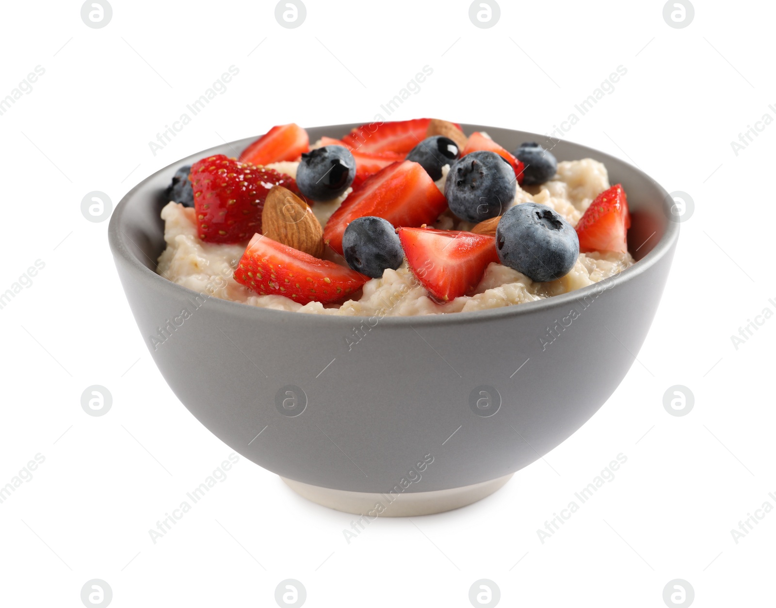 Photo of Tasty oatmeal porridge with blueberries, strawberries and almond nuts in bowl on white background