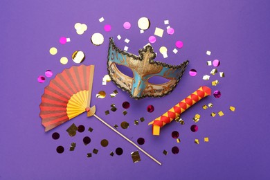 Photo of Flat lay composition with carnival items on purple background