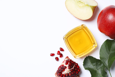 Honey, apples and pomegranate on white background, flat lay. Rosh Hashanah holiday