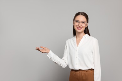 Photo of Portrait of beautiful young teacher on grey background. Space for text