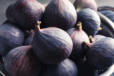 Photo of Colander with fresh ripe figs, closeup. Tropical fruit