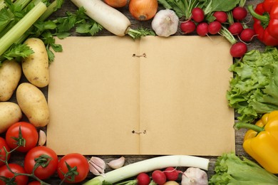 Blank recipe book and different ingredients on wooden table, flat lay. Space for text