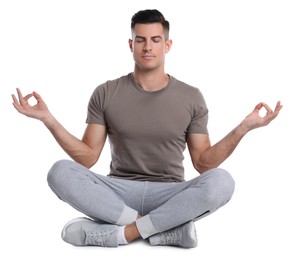 Photo of Handsome man meditating on white background. Harmony and zen