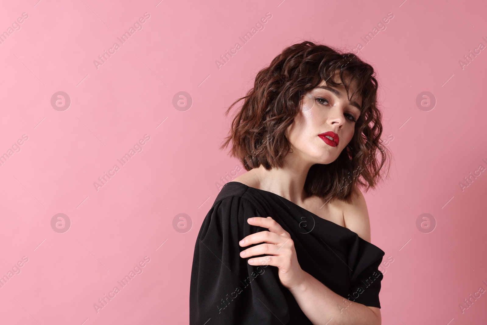 Photo of Portrait of beautiful young woman with wavy hairstyle on pink background. Space for text