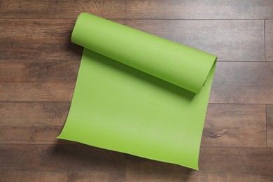 Bright camping mat on wooden background, top view