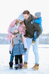 Photo of Portrait of happy family outdoors on winter day