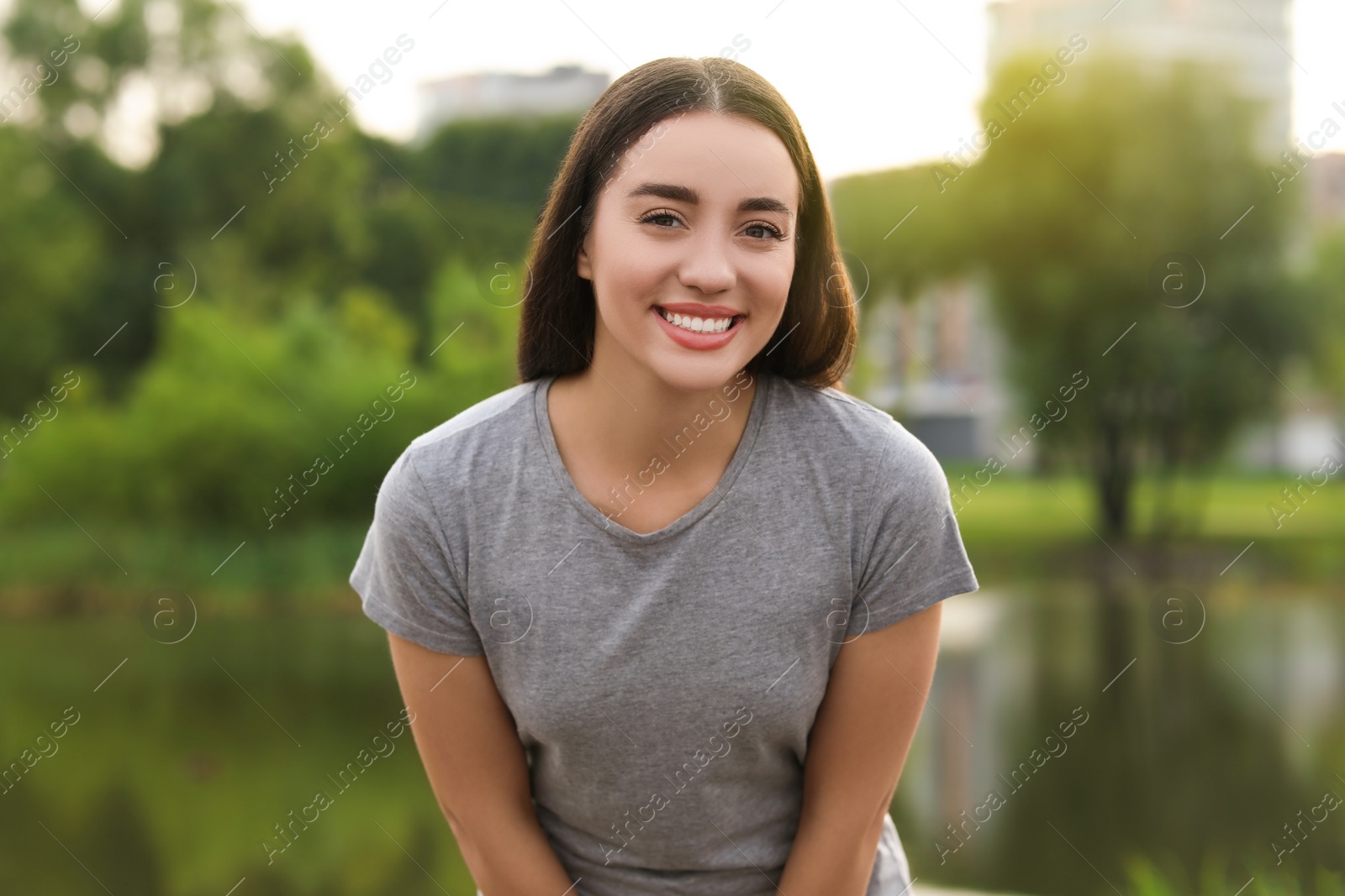 Photo of Portrait of beautiful woman outdoors. Attractive lady smiling and looking into camera
