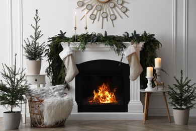 Stylish room interior with fireplace and beautiful Christmas decor