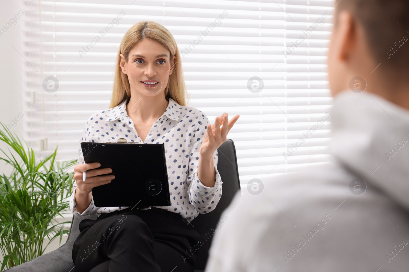 Photo of Psychologist working with teenage boy in office