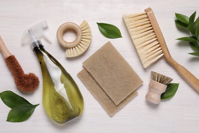 Photo of Flat lay composition with different cleaning supplies on light wooden background