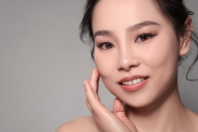 Portrait of beautiful woman on grey background