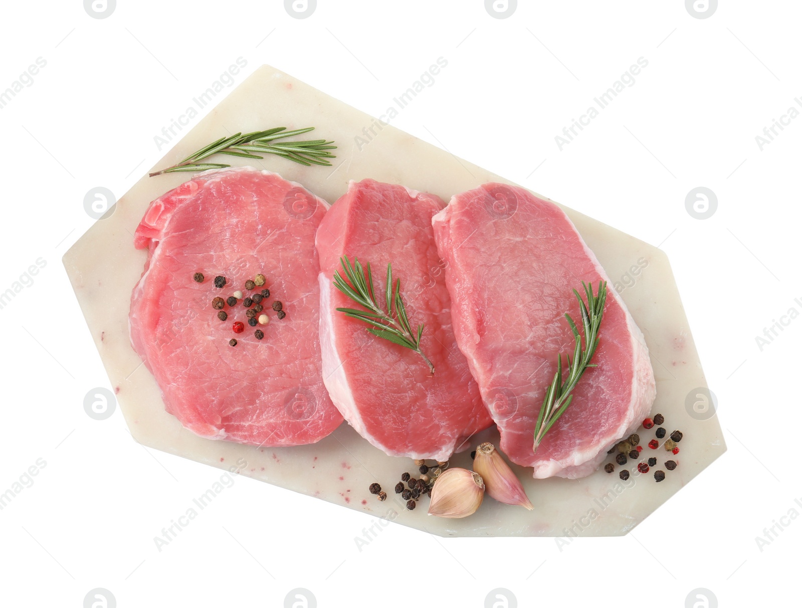 Photo of Board with pieces of raw pork meat and spices isolated on white, top view