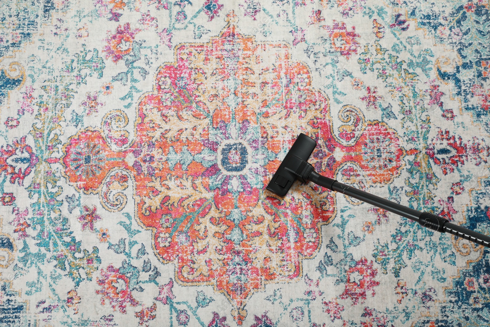Photo of Removing dirt from carpet with modern vacuum cleaner, top view. Space for text