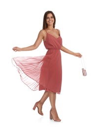 Young woman wearing stylish pale pink dress on white background