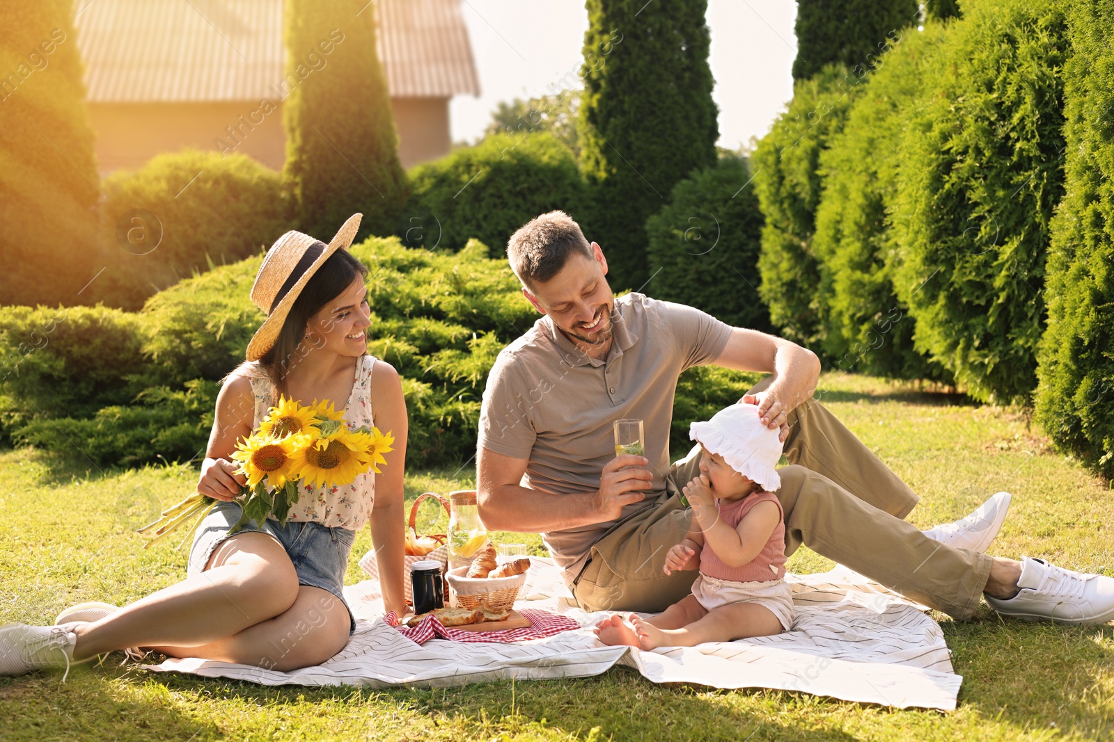 Photo of Happy family having picnic in garden on sunny day