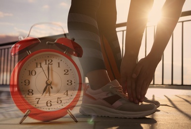 Time to do morning exercises. Double exposure of woman stretching before running outdoors and alarm clock