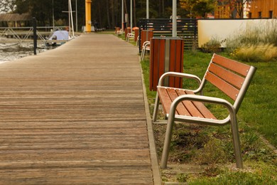 Photo of Wooden benches near pathway outdoors. Real estate