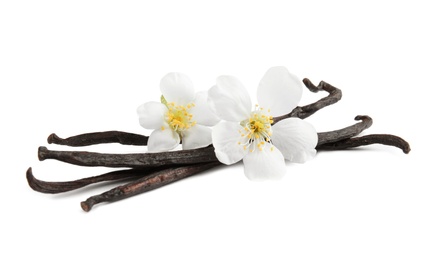Photo of Aromatic vanilla sticks and flowers on white background