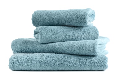 Photo of Stack of clean soft towels on white background