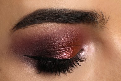 Young woman with evening makeup, closeup. Eye shadow product