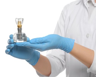 Photo of Dentist holding educational model of dental implant on white background, closeup