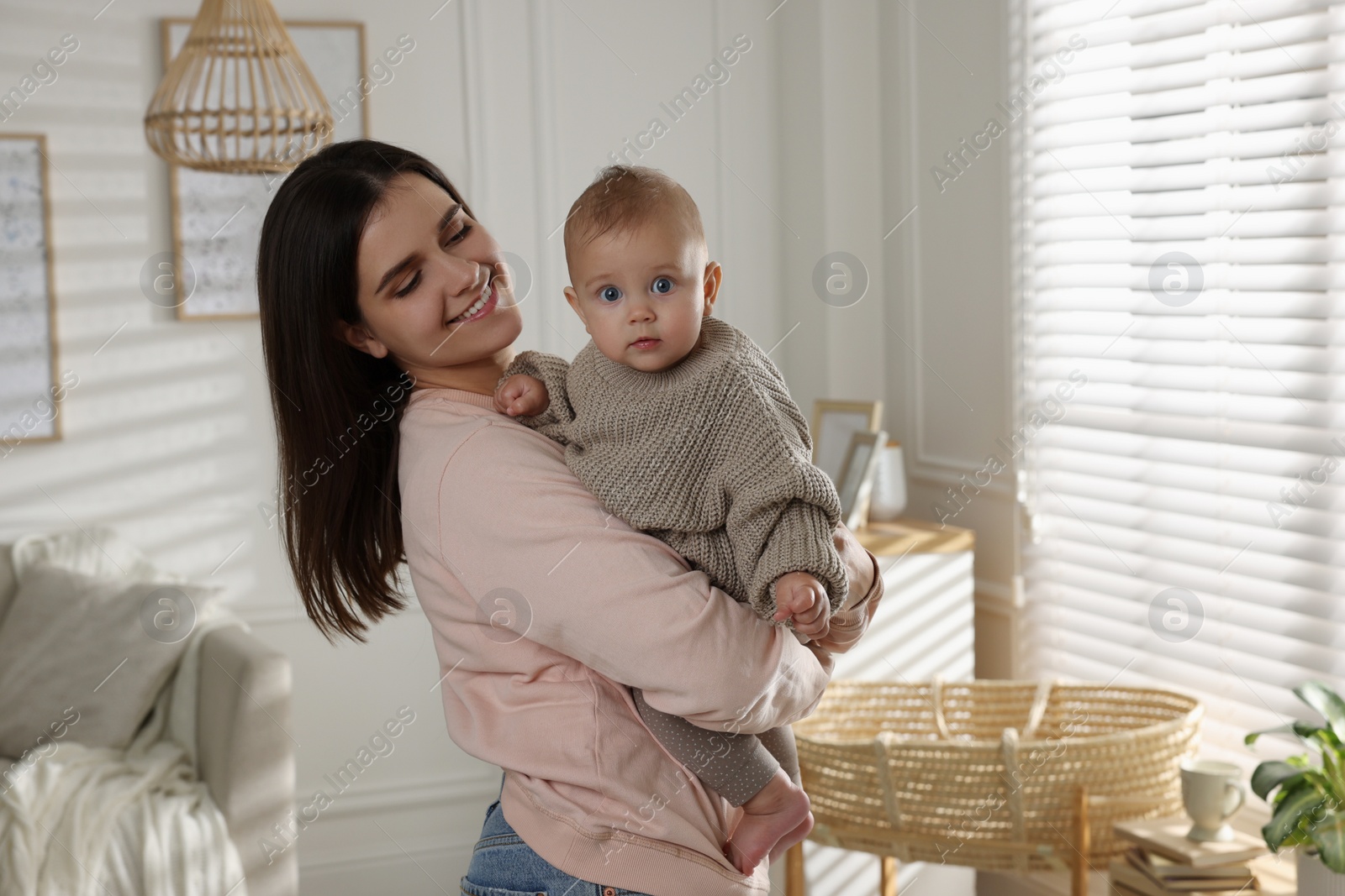 Photo of Happy young mother with her baby at home