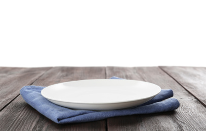 Photo of Empty plate and napkin on wooden table against white background