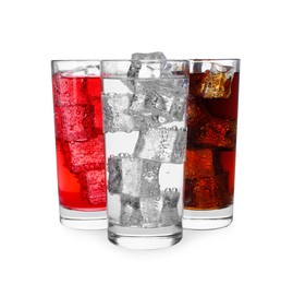 Photo of Glasses of different refreshing soda water with ice cubes isolated on white