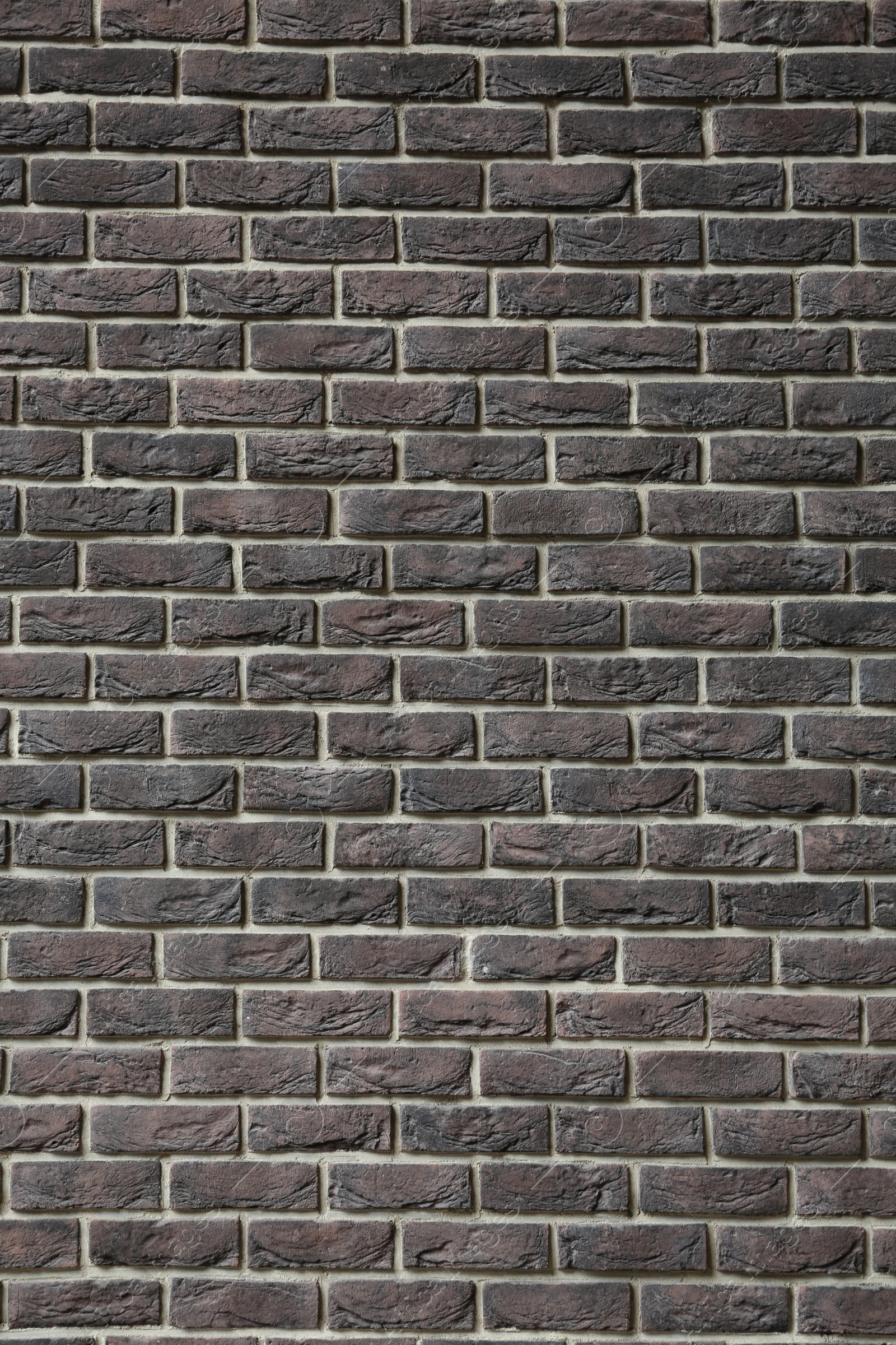 Photo of Texture of brown brick wall as background, closeup