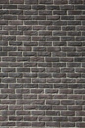 Texture of brown brick wall as background, closeup