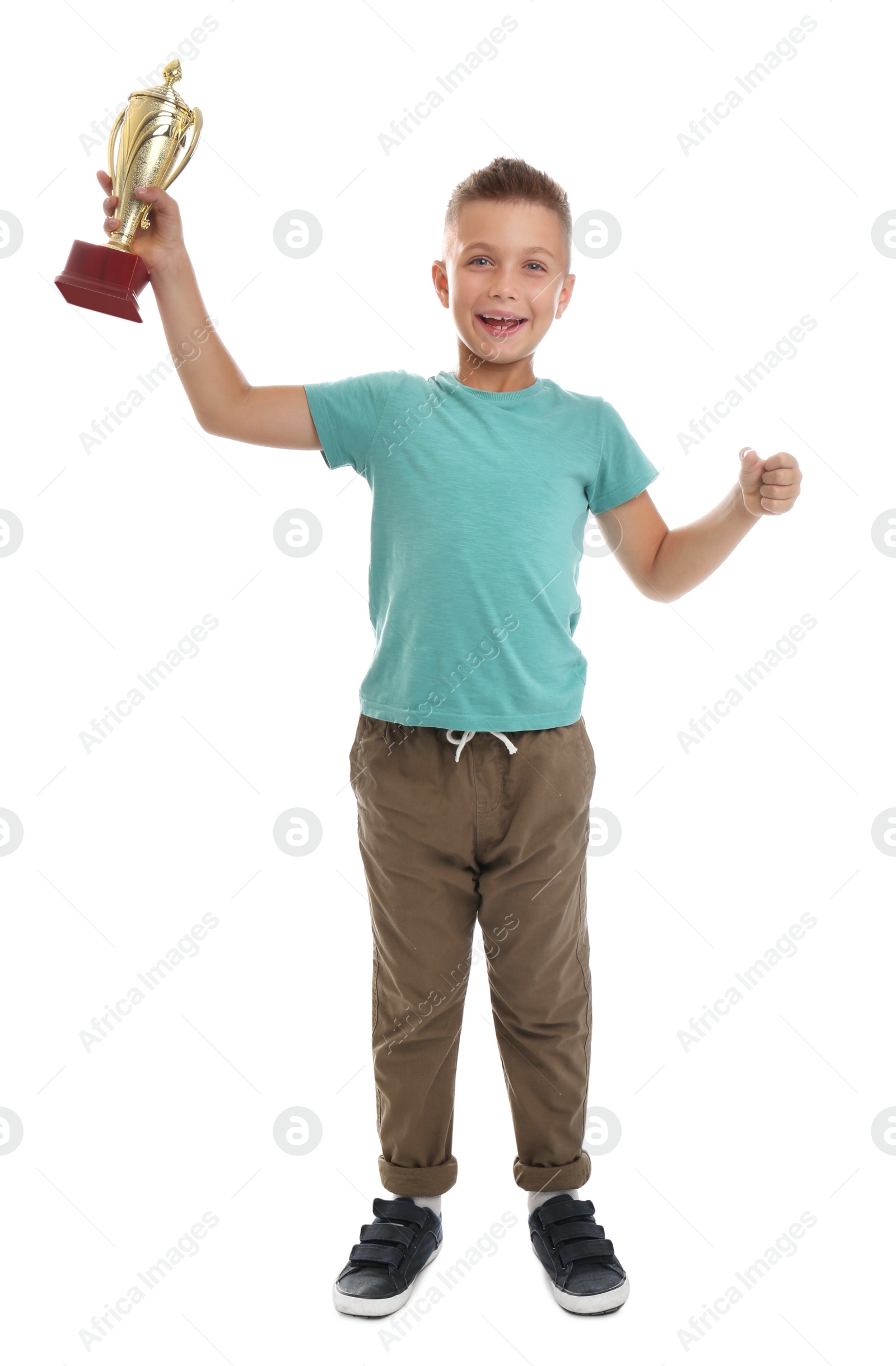 Photo of Happy boy with golden winning cup isolated on white