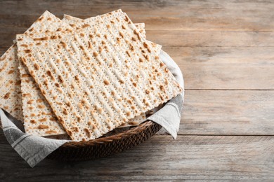 Photo of Traditional matzos in basket on wooden table