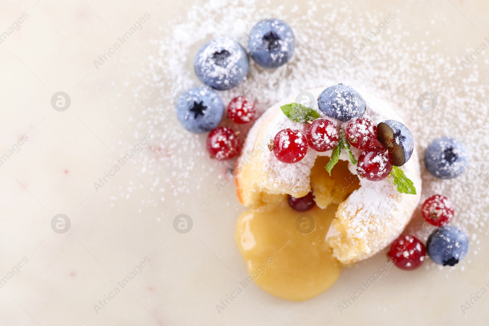 Photo of Tasty vanilla fondant with white chocolate and berries on white table, flat lay. Space for text