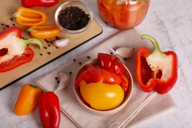 Tasty pickled peppers and fresh vegetables on table, above view