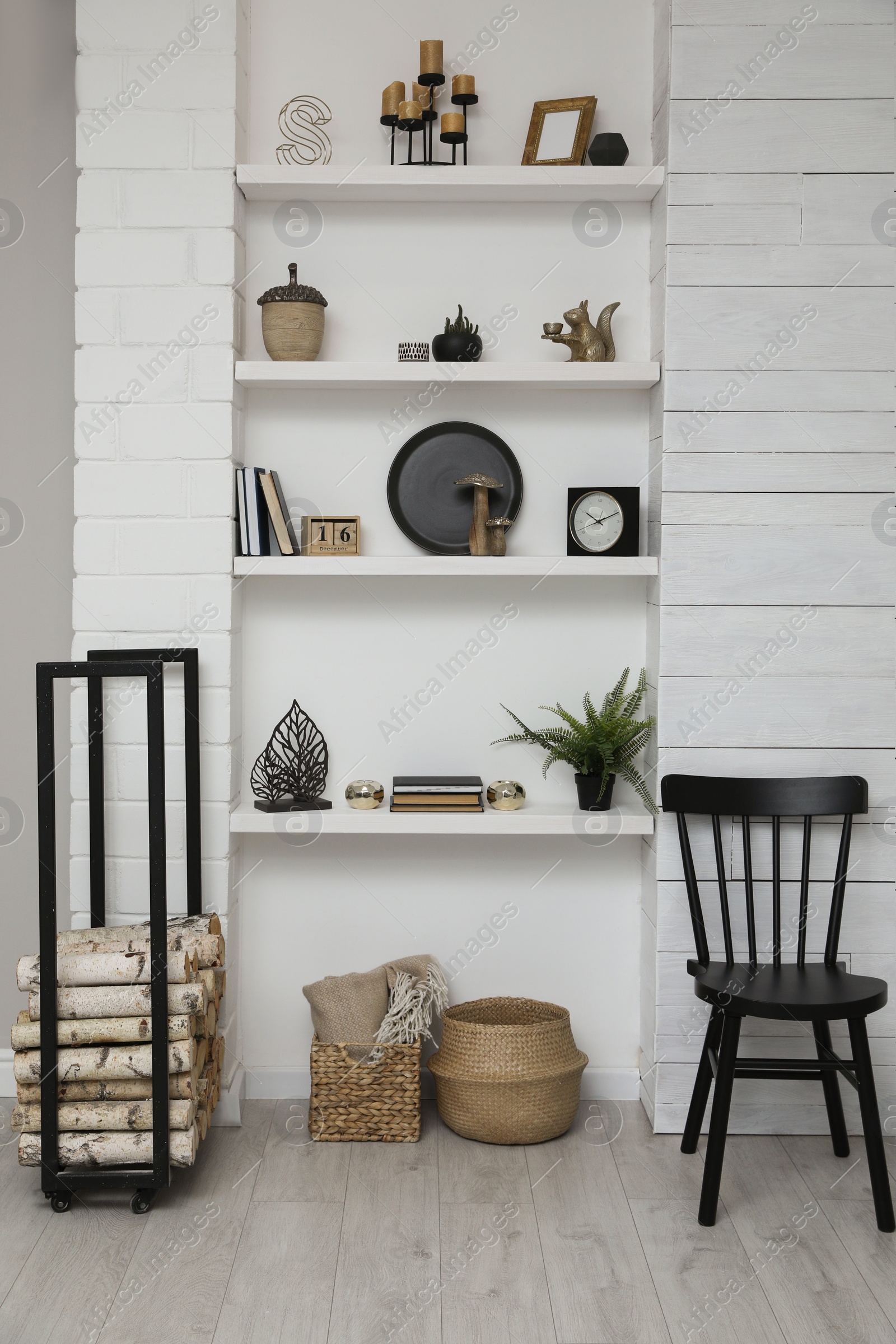 Photo of Many shelves with different decor in room. Interior design