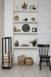 Photo of Many shelves with different decor in room. Interior design