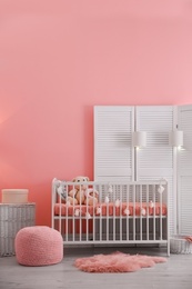 Photo of Baby room interior with decorations and comfortable crib
